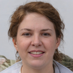 Joyful white young-adult female with medium  brown hair and blue eyes