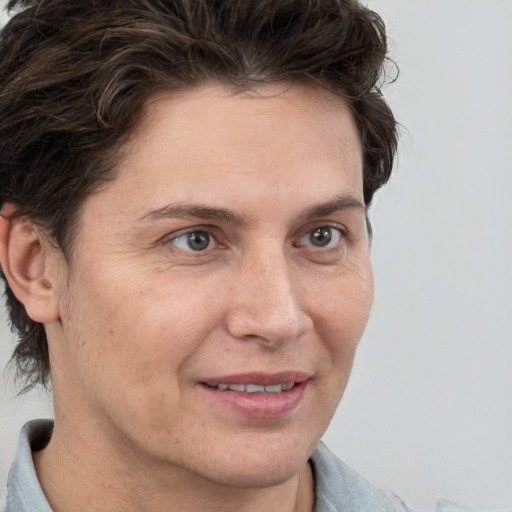 Joyful white adult female with short  brown hair and grey eyes