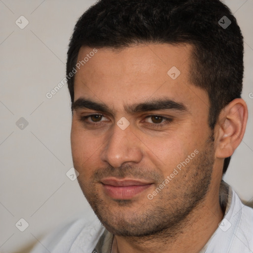 Joyful white young-adult male with short  black hair and brown eyes