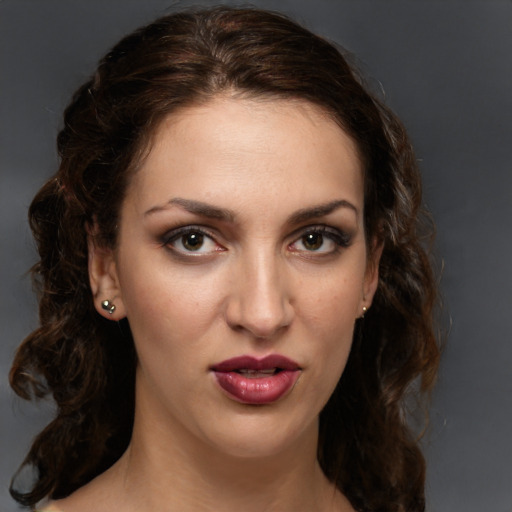 Joyful white young-adult female with medium  brown hair and green eyes