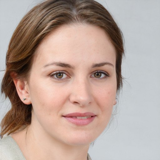 Joyful white young-adult female with medium  brown hair and blue eyes