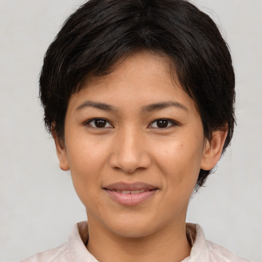 Joyful latino young-adult female with short  brown hair and brown eyes