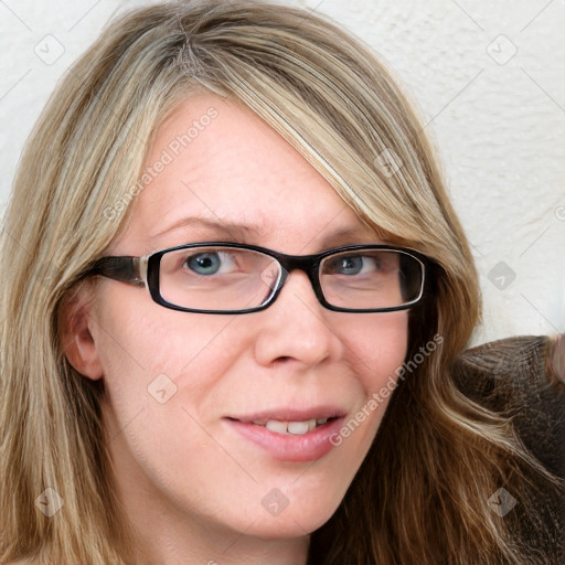 Joyful white adult female with long  brown hair and blue eyes