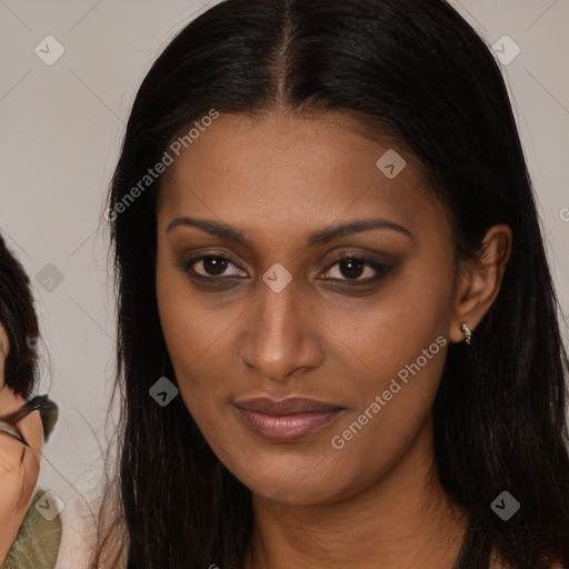 Joyful black young-adult female with long  brown hair and brown eyes