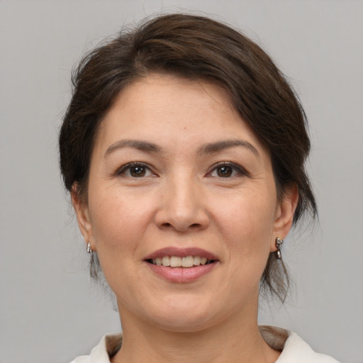 Joyful white adult female with medium  brown hair and brown eyes