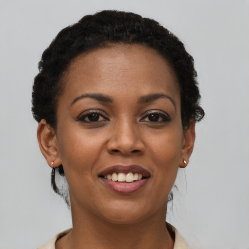 Joyful latino young-adult female with short  brown hair and brown eyes