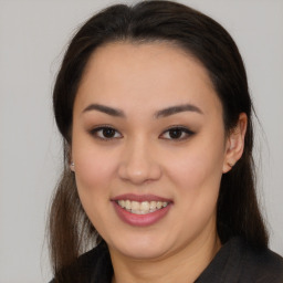 Joyful asian young-adult female with long  brown hair and brown eyes