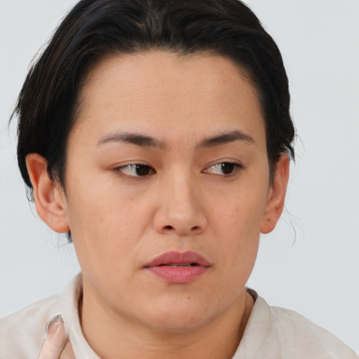 Joyful asian young-adult female with short  brown hair and brown eyes