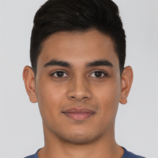 Joyful latino young-adult male with short  brown hair and brown eyes