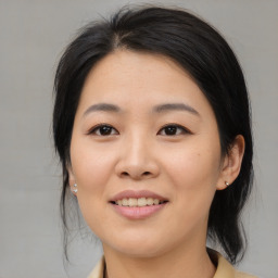 Joyful asian young-adult female with medium  black hair and brown eyes