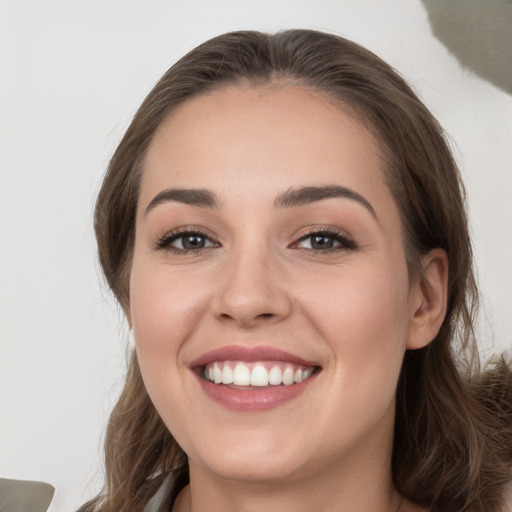 Joyful white young-adult female with long  brown hair and grey eyes