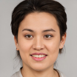 Joyful asian young-adult female with medium  brown hair and brown eyes