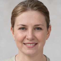 Joyful white young-adult female with short  brown hair and grey eyes