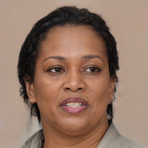 Joyful black adult female with medium  brown hair and brown eyes