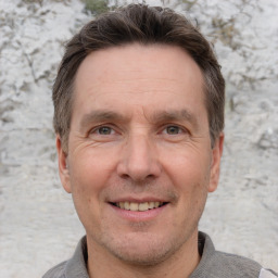 Joyful white adult male with short  brown hair and grey eyes