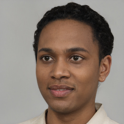 Joyful black young-adult male with short  black hair and brown eyes