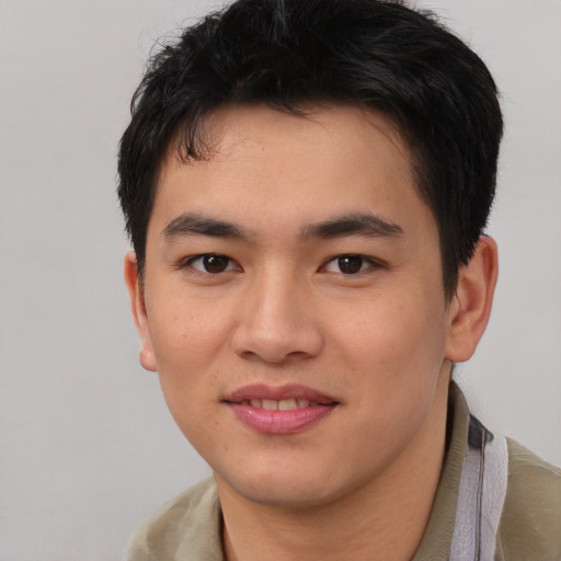 Joyful asian young-adult male with short  brown hair and brown eyes