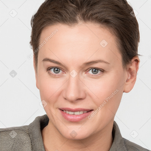 Joyful white young-adult female with short  brown hair and grey eyes