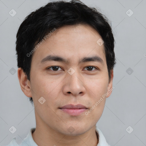 Joyful asian young-adult male with short  brown hair and brown eyes