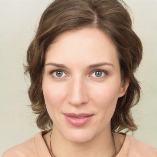 Joyful white young-adult female with medium  brown hair and green eyes