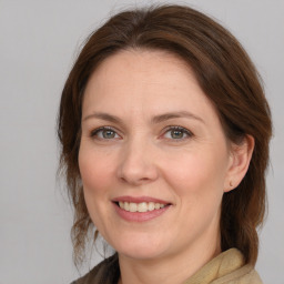 Joyful white adult female with medium  brown hair and brown eyes