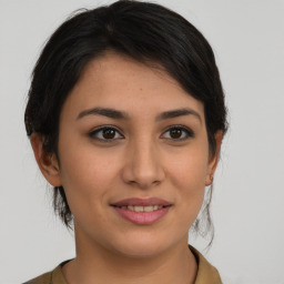 Joyful latino young-adult female with medium  brown hair and brown eyes