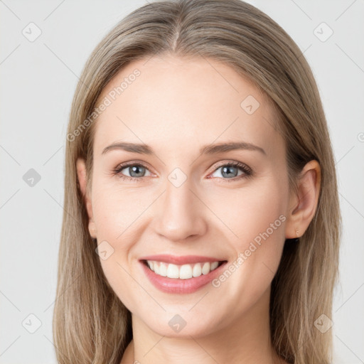 Joyful white young-adult female with long  brown hair and grey eyes