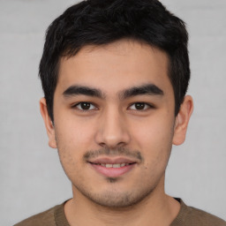 Joyful latino young-adult male with short  brown hair and brown eyes