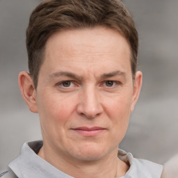 Joyful white adult male with short  brown hair and grey eyes