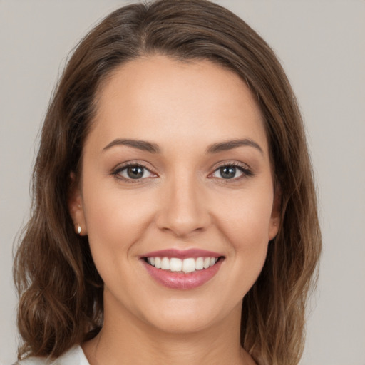 Joyful white young-adult female with medium  brown hair and brown eyes