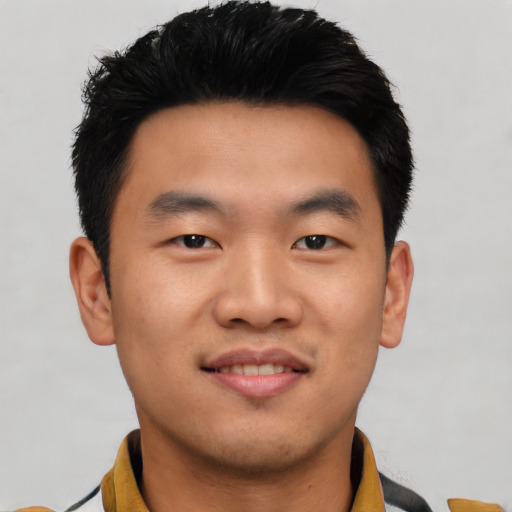 Joyful asian young-adult male with short  black hair and brown eyes