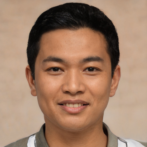 Joyful asian young-adult male with short  black hair and brown eyes