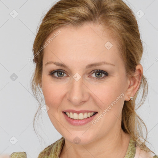 Joyful white young-adult female with medium  brown hair and grey eyes