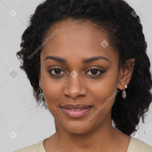 Joyful black young-adult female with long  black hair and brown eyes