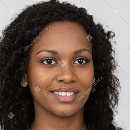 Joyful black young-adult female with long  brown hair and brown eyes