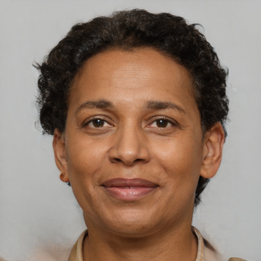 Joyful black adult female with short  brown hair and brown eyes