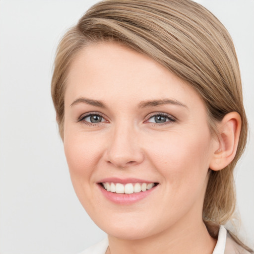 Joyful white young-adult female with medium  brown hair and grey eyes