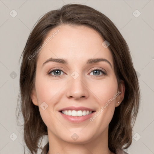 Joyful white young-adult female with medium  brown hair and green eyes