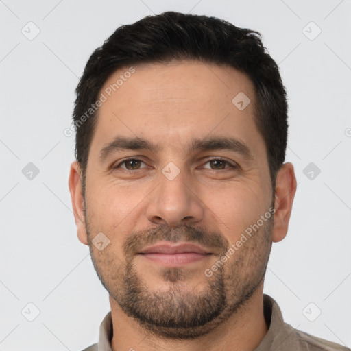 Joyful white adult male with short  brown hair and brown eyes