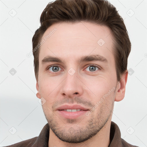 Joyful white young-adult male with short  brown hair and grey eyes