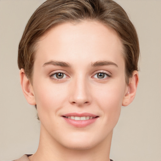 Joyful white young-adult female with short  brown hair and grey eyes