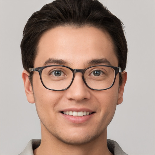 Joyful white young-adult male with short  brown hair and grey eyes