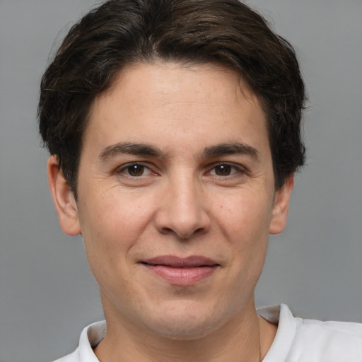 Joyful white adult male with short  brown hair and brown eyes