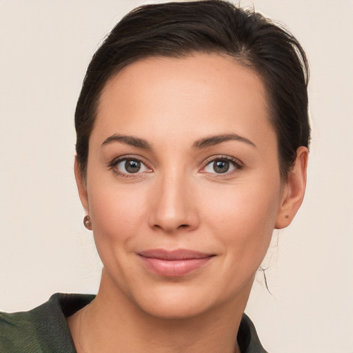 Joyful white young-adult female with medium  brown hair and brown eyes