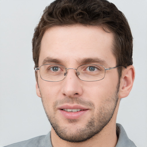 Joyful white adult male with short  brown hair and grey eyes