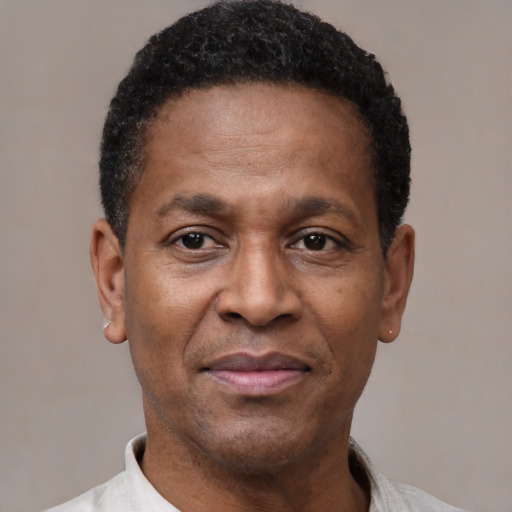 Joyful latino adult male with short  black hair and brown eyes