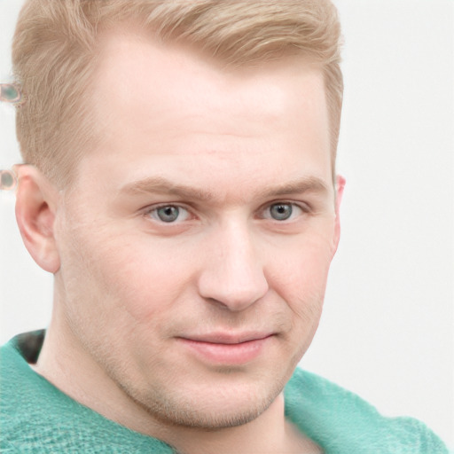 Joyful white young-adult male with short  brown hair and blue eyes