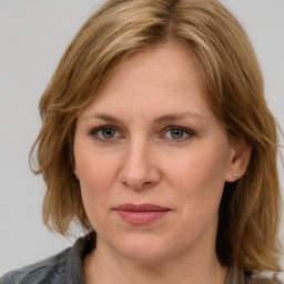 Joyful white adult female with medium  brown hair and grey eyes