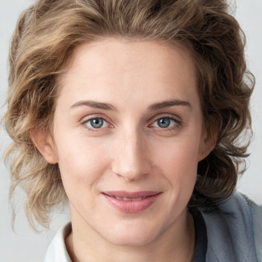 Joyful white young-adult female with medium  brown hair and blue eyes