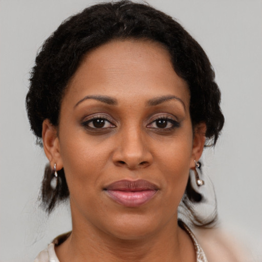 Joyful black young-adult female with medium  brown hair and brown eyes
